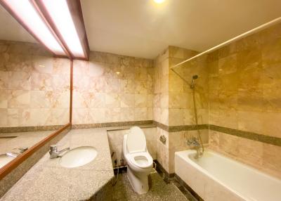 Spacious bathroom with marble tiles and modern fixtures