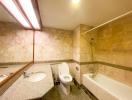 Spacious bathroom with marble tiles and modern fixtures