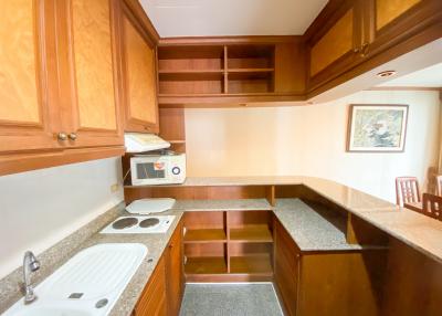 Spacious kitchen with wooden cabinets and granite countertops