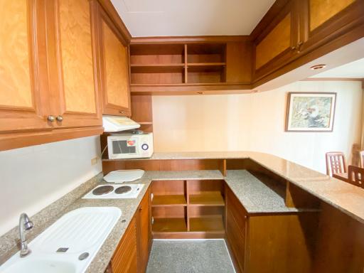 Spacious kitchen with wooden cabinets and granite countertops