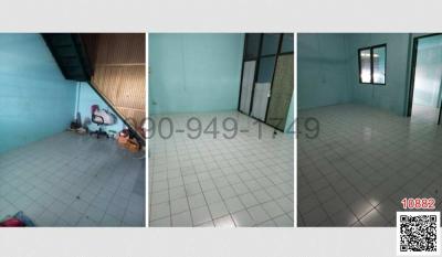 Spacious empty interior of a residential building with tiled flooring and good natural lighting