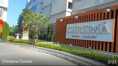 Exterior view of Chrisma Condo with signboard