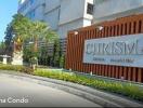 Exterior view of Chrisma Condo with signboard