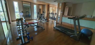 Home gym with exercise equipment and large windows