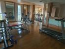 Home gym with exercise equipment and large windows