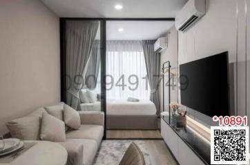 Modern bedroom with a view into the living room, furnished with large bed, wardrobe, and flat-screen TV