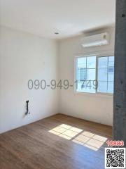Unfurnished and bright room with large window and air conditioning unit