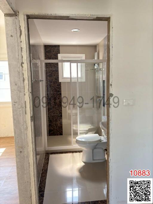 Modern styled bathroom with a glass shower cabin and a toilet