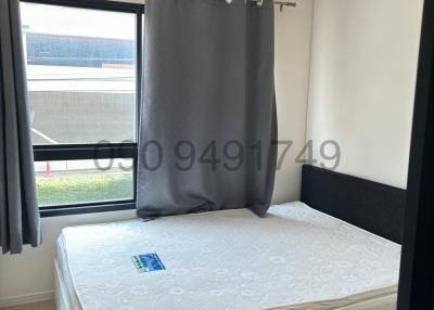 Modern bedroom with large window and comfortable double bed