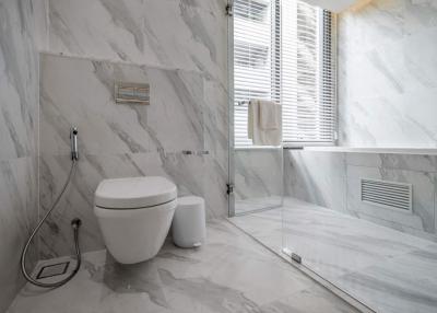 Modern bathroom with marble tiles and glass shower