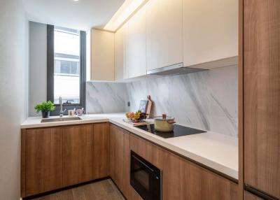 Modern kitchen with marble countertops and wooden cabinets