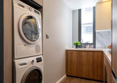 Modern laundry area with stacked washer and dryer in a well-lit room