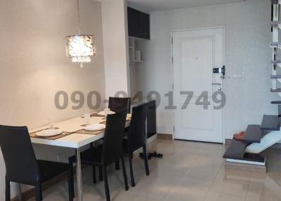 Modern dining area with staircase and living space