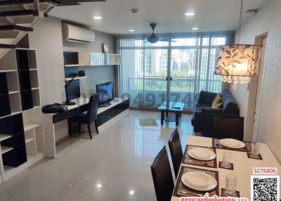 Spacious and well-lit living room with modern furniture and balcony access