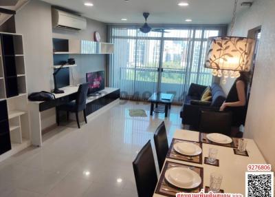 Spacious and well-lit living room with modern furnishings and balcony access