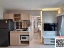 Modern kitchen with wooden cabinets and integrated appliances opening to a living space