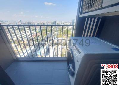 Compact balcony with a washing machine and city view