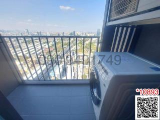 Compact balcony with a washing machine and city view