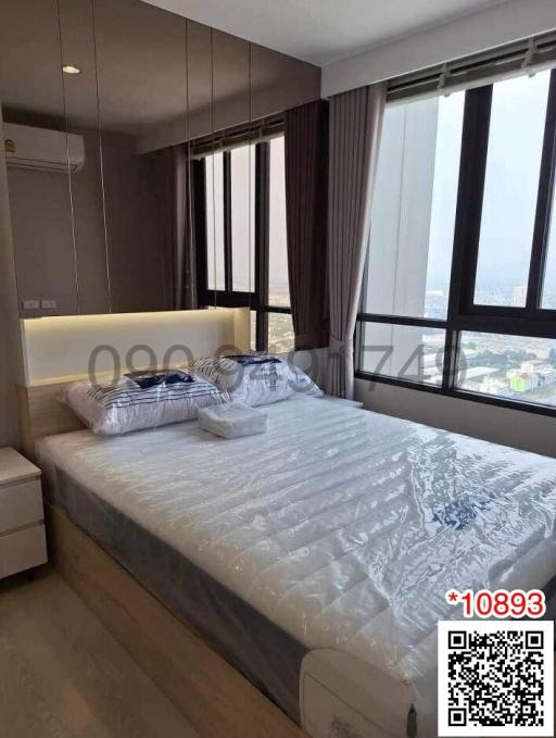 Modern bedroom with large window and city view