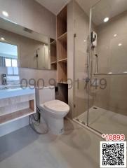 Modern bathroom with glass shower enclosure and wooden shelves