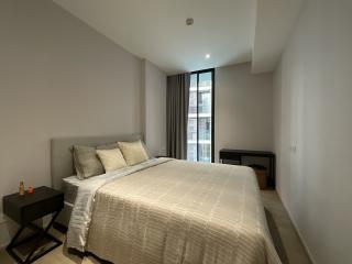 Spacious bedroom with large bed, ambient lighting and a view from the window.