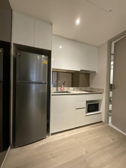 Modern kitchen with stainless steel appliances and wooden flooring