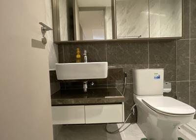 Modern bathroom interior with wall-mounted sink and toilet