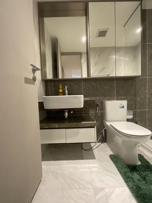 Modern bathroom interior with wall-mounted sink and toilet