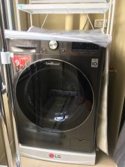 Modern LG washing machine in a well-kept laundry space