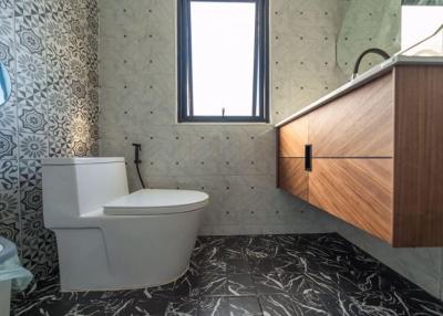 Modern bathroom interior with patterned tiles and wooden vanity