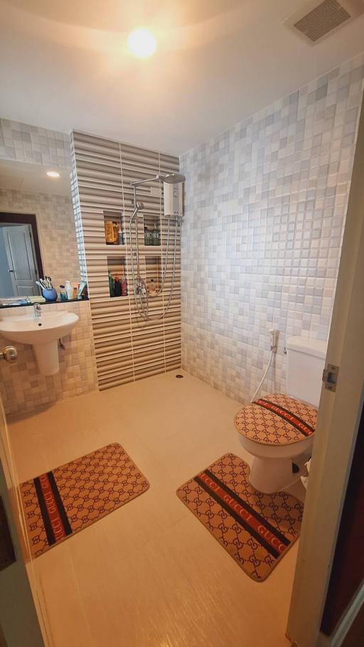 Spacious modern bathroom with walk-in shower and dual-function toilet