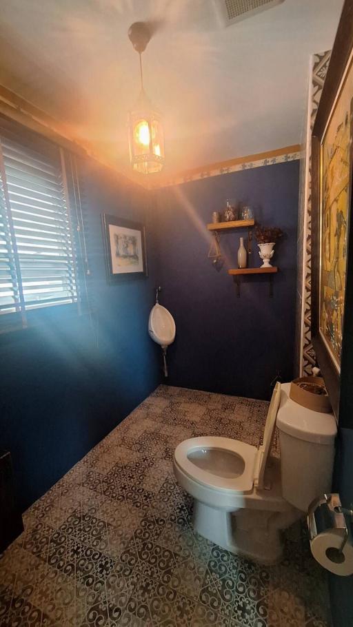 Elegantly Decorated Bathroom with Patterned Flooring and Blue Walls