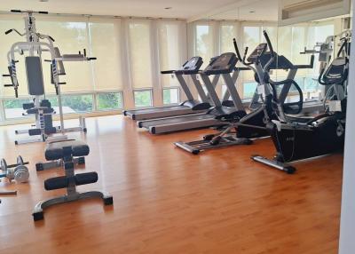 Spacious in-home gym with exercise machines and large windows
