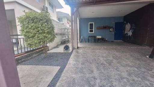 Spacious exterior view of a residential property with a driveway and partial view of the adjacent house