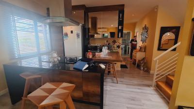 Modern kitchen with open dining area and staircase