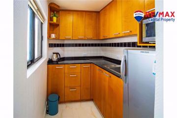 Compact kitchen with wood cabinets and modern appliances