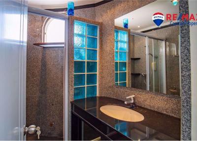 Modern bathroom interior with shower and blue glass window