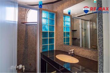 Modern bathroom interior with shower and blue glass window