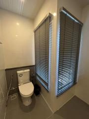 Modern bathroom with natural light and privacy blinds