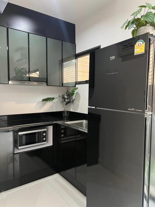 Modern kitchen with stainless steel appliances and black cabinetry