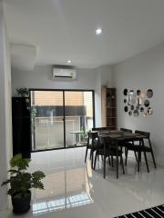 Modern dining area with natural light and balcony access