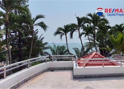 Spacious balcony with ocean view surrounded by palm trees