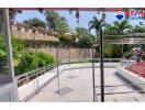 Spacious outdoor patio with tiled flooring and metal railing