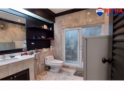Spacious modern bathroom with walk-in shower and marble tiles