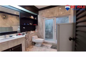 Spacious modern bathroom with walk-in shower and marble tiles