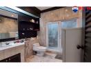 Spacious modern bathroom with walk-in shower and marble tiles