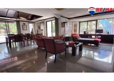 Spacious living room with dining area and gleaming floor tiles