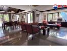 Spacious living room with dining area and gleaming floor tiles