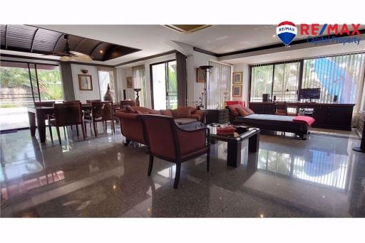 Spacious living room with dining area and gleaming floor tiles