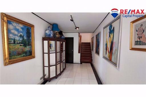 Bright hallway with artwork and staircase